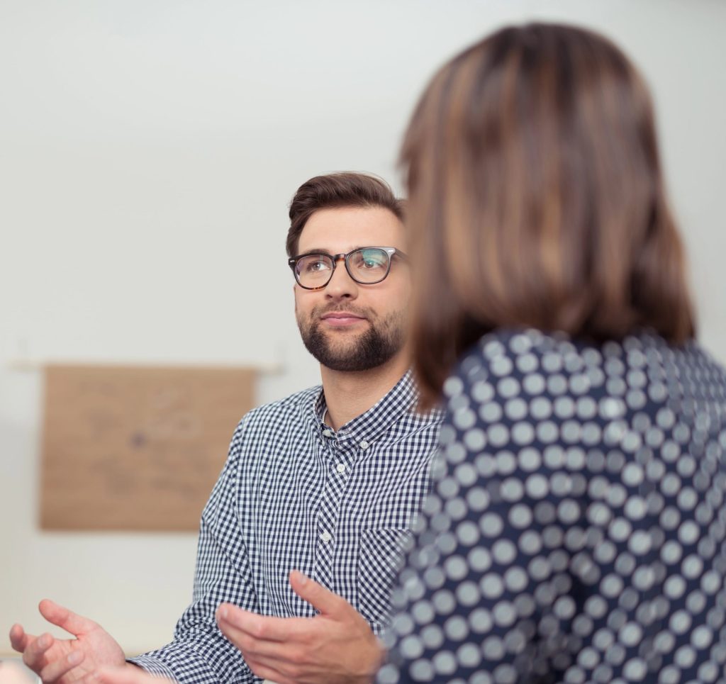 A man and woman are engaged in a conversation, possibly discussing something important.