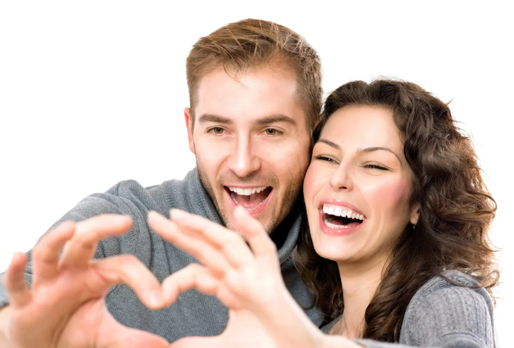 A smiling couple making a heart shape with their hands, conveying happiness. Articles on marriage might be related.