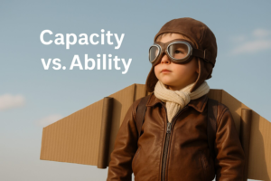 A child dressed as an aviator stands with cardboard wings. The text reads "Capacity vs. Ability."